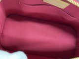 the inside of a red purse with gold zippers on it