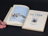 a person holding an open book with a picture on it