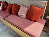 a couch with many pillows on it in a room