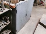 a metal cabinet that has a bunch of tools on it