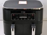an air fryer sitting on top of a counter next to a white wall