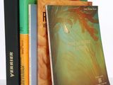 three books are stacked on top of each other on a table