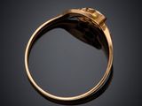a close up of a gold ring with a diamond in the center