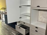 a white cabinet with drawers in the middle of the room