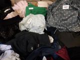 a pile of clothes that is sitting on the floor