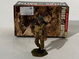 figurine of a soldier with a rifle in front of a box