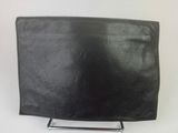 a black leather purse sitting on top of a metal stand