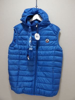 a close up of a blue vest hanging on a wall