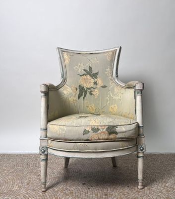 an old chair with floral upholstered upholstered back and arms