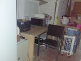 an image of a kitchen with a refrigerator and a table