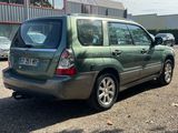a green car that is parked in a parking lot
