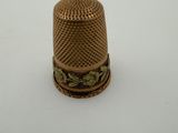 an antique thimble on a white surface with a white background