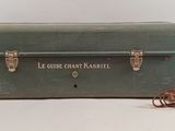 a green suitcase that is sitting on a white surface
