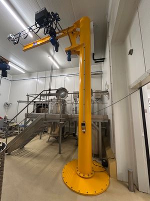a yellow crane that is in the middle of a room