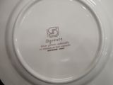 a white plate with a brown and white design on it