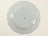 a white plate with a blue flower on it