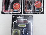 three star wars action figures sit on top of each other