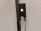 a close up of a bow with a stick attached to it