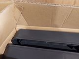 a cardboard box with two black electronic devices inside of it