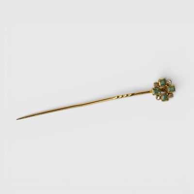 a gold and emerald flower hair pin