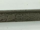 a close up of a knife on a white surface