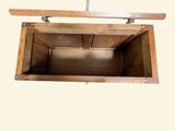 a wooden box with a handle hanging from the ceiling