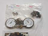 a bag of assorted items that include a clock and a purse