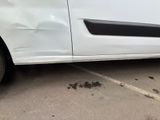 the side of a white car with a black stripe on it