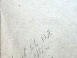an old book with writing on it sitting on a table