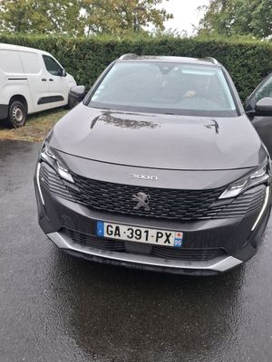 a grey car parked in a parking lot next to other cars