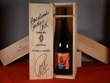 a wooden box with a bottle of wine inside of it