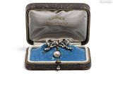 a box with a broochee and a ring inside of it