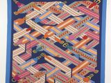 an image of a colorful quilt hanging on a wall