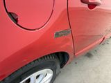 a red car that is parked on the side of the road