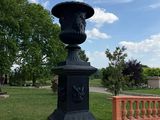 a statue of a man on a pedestal in a park