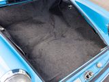 a blue car with its trunk open in a parking lot
