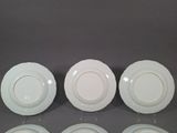three white plates sitting on top of a table next to each other