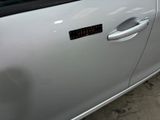 a silver car with a sticker on the side of it