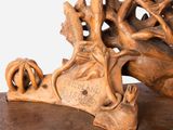 a wooden sculpture of a horse and a bird on a table