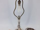 an old fashioned lamp with a cord attached to it