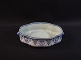a blue and white bowl sitting on a black surface