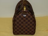 louis vuitton damier speedy bag on a yellow cloth