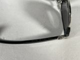 a pair of glasses that are laying on a white surface