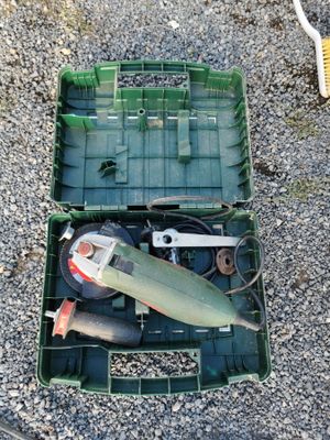 a green box with tools in it sitting on the ground