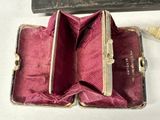 an old suitcase with a red lining and a key in it