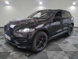 the black jaguar suv is parked on a checkered tile floor