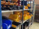 many different types of tools on the shelves in this room