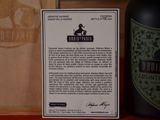 a bottle of wine sitting next to a wooden box