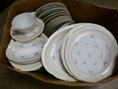 many plates and bowls in a box on the floor