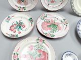 many plates and bowls that are on a table